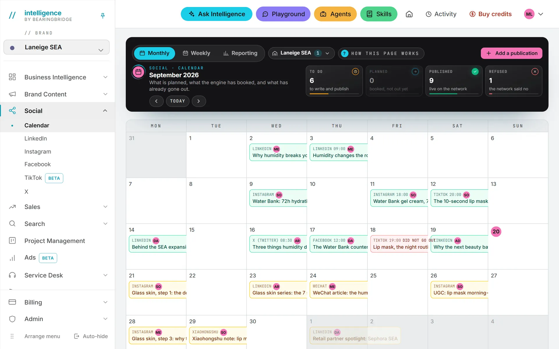 The Social calendar in month view, with a colored chip on every day that carries a post
